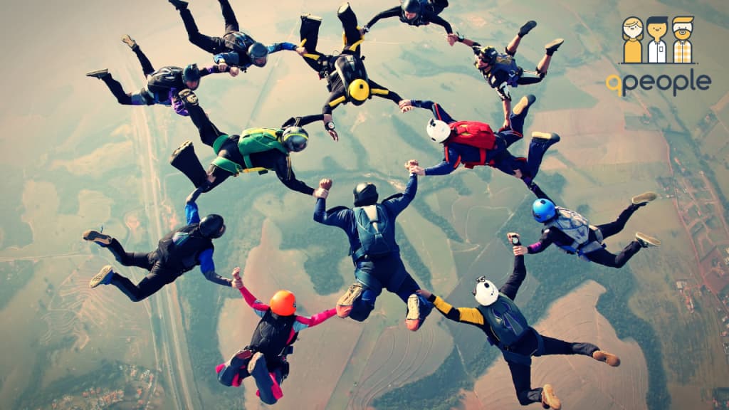 people skydiving holding hands in a group